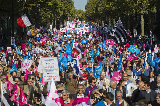 Demonstrators march with flags and placards during a rally to protest gay marriage in Paris