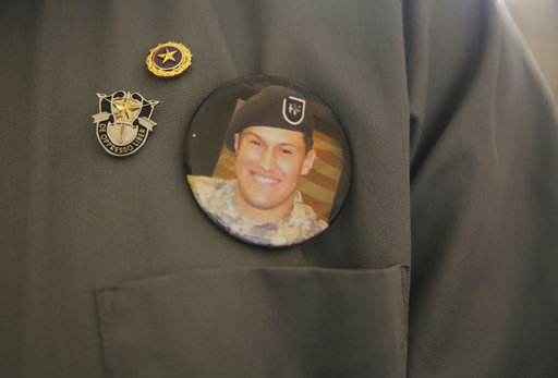 A badge with a photo of 1st Sgt. Matthew Lewellen