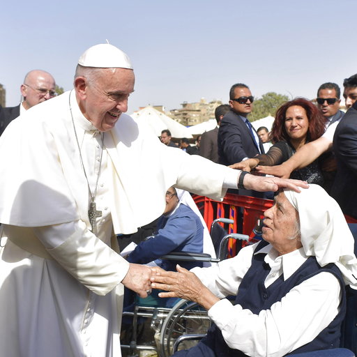 Pope Francis caresses a nun during a meeting with the clergy and religious