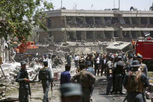 Security forces inspect the site of a suicide attack where German Embassy is located in Kabul
