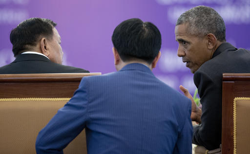 Laotian President Bounnhang Vorachit and U.S. President Barack Obama talk with the help of a translator during an Official State Luncheon at the Presidential Palace in Vientiane