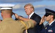 President Donald Trump walks down the steps of Air Force One at Morristown Municipal Airport in Morristown