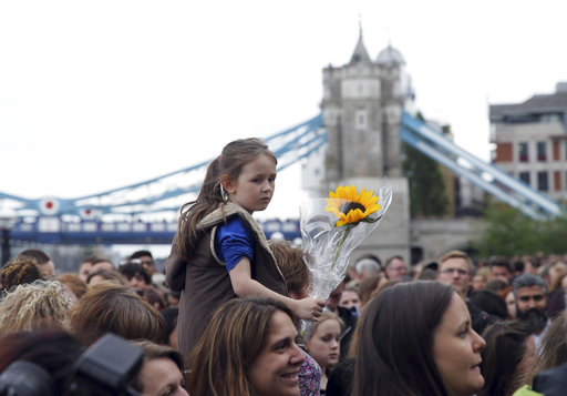 People attend a vigil for victims of Saturday's attack in London Bridge