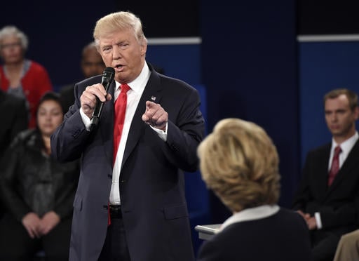 Republican presidential nominee Donald Trump points at Democratic presidential nominee Hillary Clinton as he speaks during the second presidential debate at Washington University in St. Louis