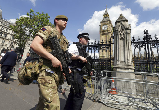 A member of the army joins police officers in Westminster