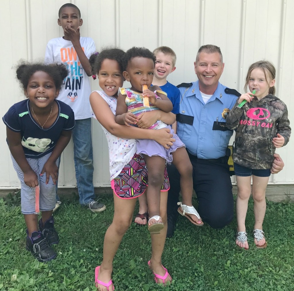 Stamping Ground Police Chief Roger Nowakowski with children in Cops-N-Pops program in July 2017