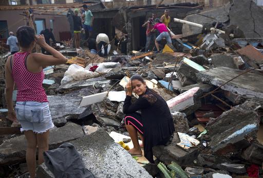 A woman cries amid the rubble of her home