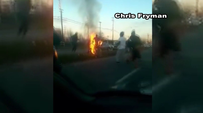 Chris Fryman captures firefighter helping man on fire