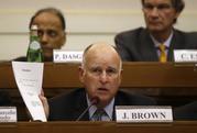 California Gov. Jerry Brown shows a paper during a workshop organized by Vatican on the climate change