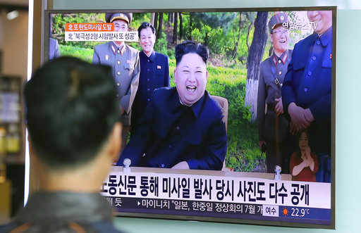 A man watches a TV news program showing image of North Korean leader Kim Jong Un