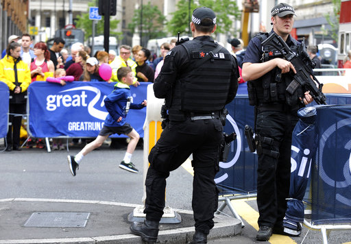 Armed police guard the area during the Great Manchester Run in Manchester