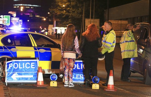 Police work at Manchester Arena after reports of an explosion at the venue during an Ariana Grande gig in Manchester