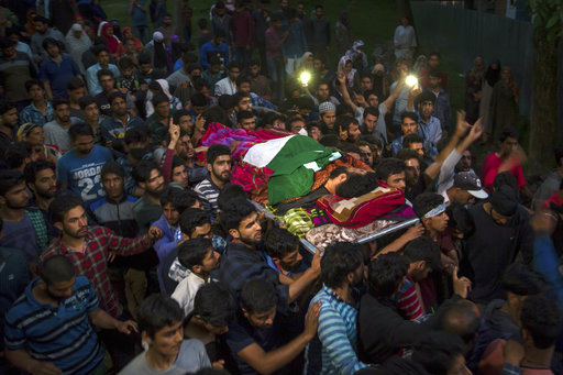 Kashmiri villagers carry the body of rebel leader Sabzar Ahmed Bhat towards his home after displaying his body in Tral area
