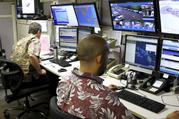 Hawaii Emergency Management Agency officials work at the department's command center in Honolulu on Friday
