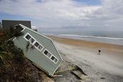 A house rests on the beach after collapsing off a cliff from Hurricane Irma in Vilano Beach