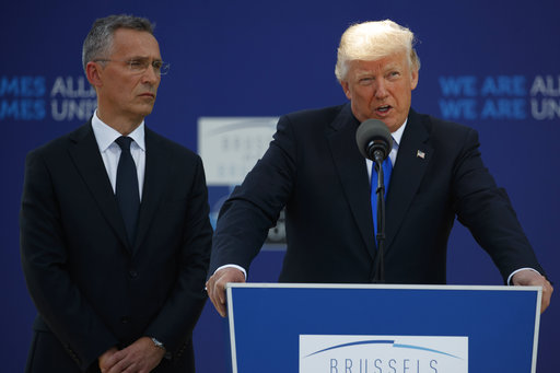 NATO Secretary General Jens Stoltenberg listens as President Donald Trump speaks during a ceremony to unveil artifacts from the World Trade Center and Berlin Wall for the new NATO headquarters