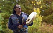 Dennis Zotigh poses for a photo outside the National Museum of the American Indian in Washington