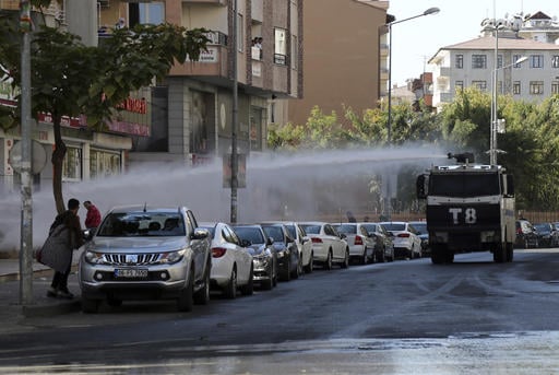 Police use water cannons against pro-Kurdish Peoples's Democratic Party members as they protest the detention of Gultan Kisanak