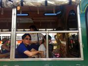 Visitors sit on a tour bus in Tumon