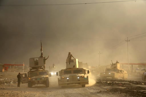 An Iraqi military convoy advances towards the city of Mosul