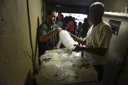 People buy ice during a massive blackout in San Juan