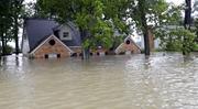 A home is surrounded by floodwaters from Tropical Storm Harvey on Monday