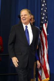 Democrat Doug Jones smiles as he arrives to speak Tuesday