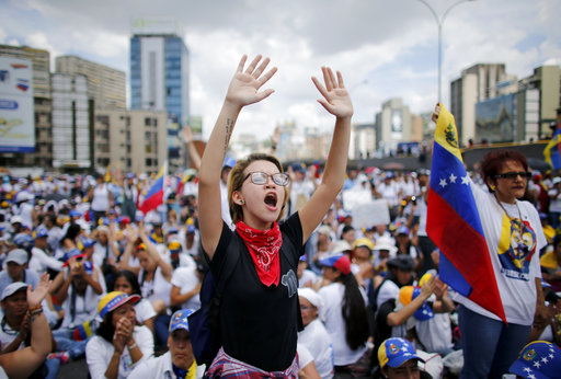 Anti-government protesters stage a sit-in blocking the Franciso Fajardo highway during a women's march against repression in Caracas