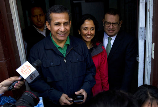 Peru's former President Ollanta Humala and his wife Nadine Heredia stop to talk with journalists as they leave the headquarters of Peru's National Party where they met with their lawyers