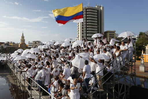 People wait for the start of the peace ceremony prior the signing of a peace agreement between Colombias government and the Revolutionary Armed Forces of Colombia