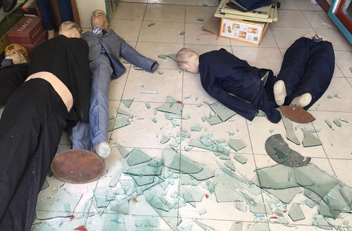 Mannequins are fallen on the ground of a damaged shop near the site of a suicide attack in Kabul