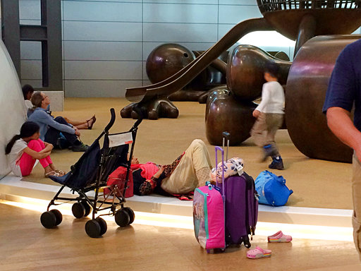 Passengers of cancelled flights wait in Hamad International Airport (HIA) in Doha