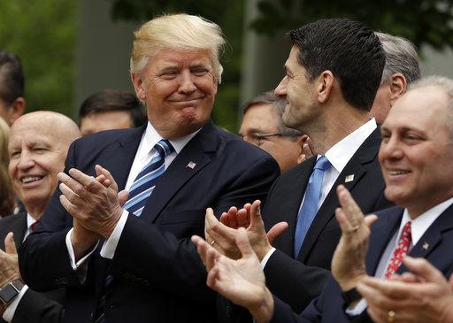 President Donald Trump talks with House Speaker Paul Ryan of Wis.