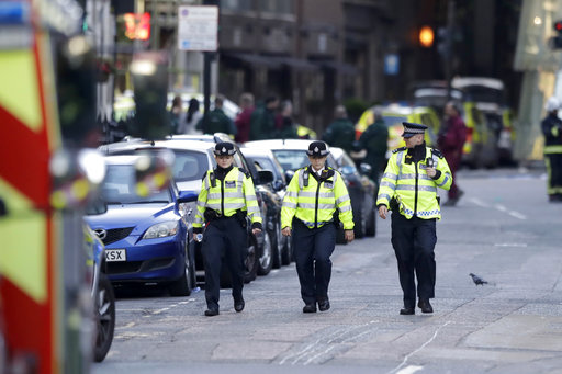 British police officers walk within a cordoned off area after an attack in the London Bridge area of London