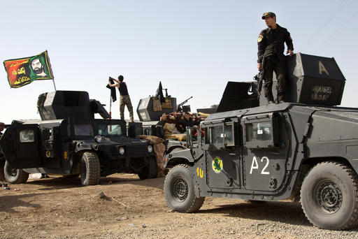Iraqi special forces soldiers deployed for an offensive to retake Mosul from Islamic State militants prepare to move out from a camp near Khazer