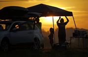 A family sets up a tent at their campsite at sunrise for the solar eclipse Monday