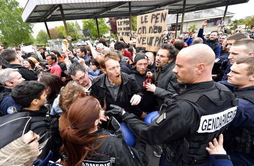 French Gendarmes control protestors far-right presidential candidate Marine Le Pen as she faces hostile reception from protesters in Dol-de-Bretagne