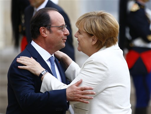 French President Francois Hollande greets German Chancellor Angela Merkel prior to their meeting at the Elysee Palace in Paris
