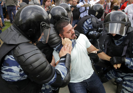 Police detain a protester during a demonstration in downtown Moscow