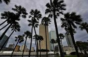 Storm clouds associated with the outer bands of Hurricane Irma shroud the downtown skyline Saturday