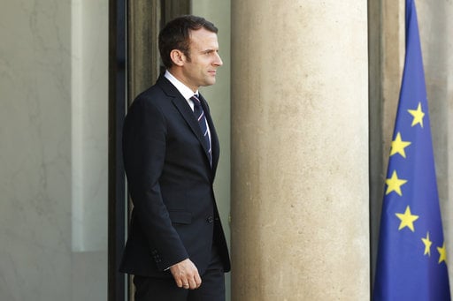 French President Emmanuel Macron waits to welcome UN Secretary General Antonio Guterres at the Elysee Palace in Paris