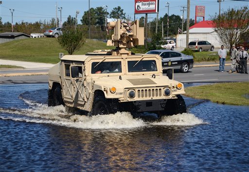 A North Carolina National Guard vehicle drives through high water along NC 11 at Skinner's Bypass in Kinston