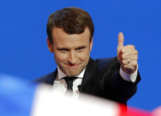 French centrist presidential candidate Emmanuel Macron thumbs up as he addresses his supporters at his election day headquarters in Paris