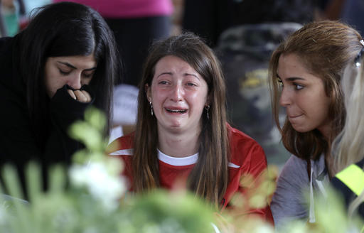 A woman cries ahead of a state funeral for some of the victims of last Wednesday's earthquake