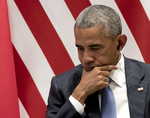 U.S. President Barack Obama listens to translation as he sits on stage during a climate change event with Chinese President Xi Jinping and U.N. Secretary-General Ban Ki-moon at the Ruyi Hall at West Lake State Guest House in Hangzhou in eastern China's Zhejiang province