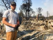 Resident Ryan Nelson goes through the ruins of his house to try to find his grandfather's rifles in Santa Rosa