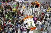 Flowers and candles are left at a makeshift memorial site on Las Vegas Boulevard on Tuesday