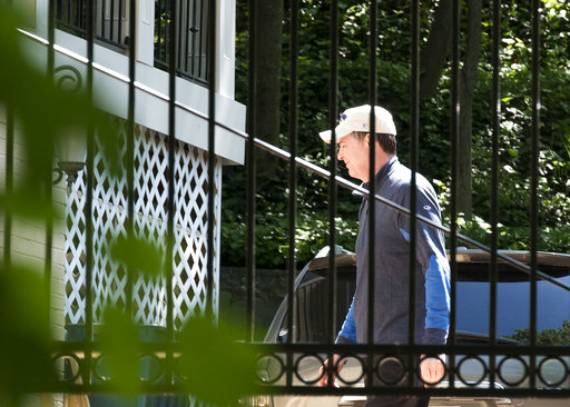 Former FBI Director James Comey walks at his home in McLean