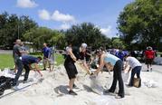 City of Miami volunteers help residents fill free sandbags Thursday