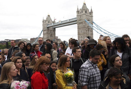 People queue to lay flowers after a vigil for victims of Saturday's attack in London Bridge